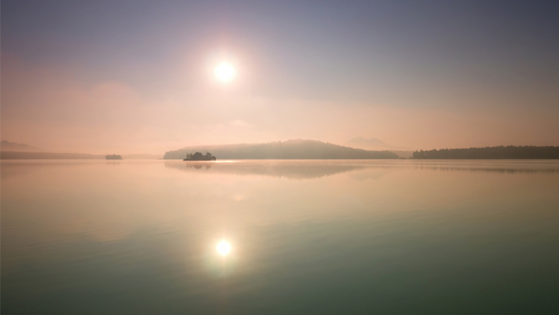 Image showing the sun and its reflection in water.