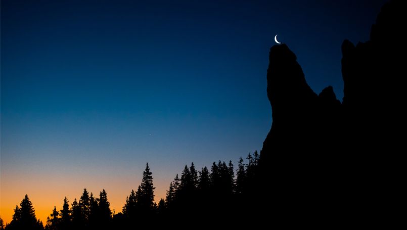 New moon above mountain